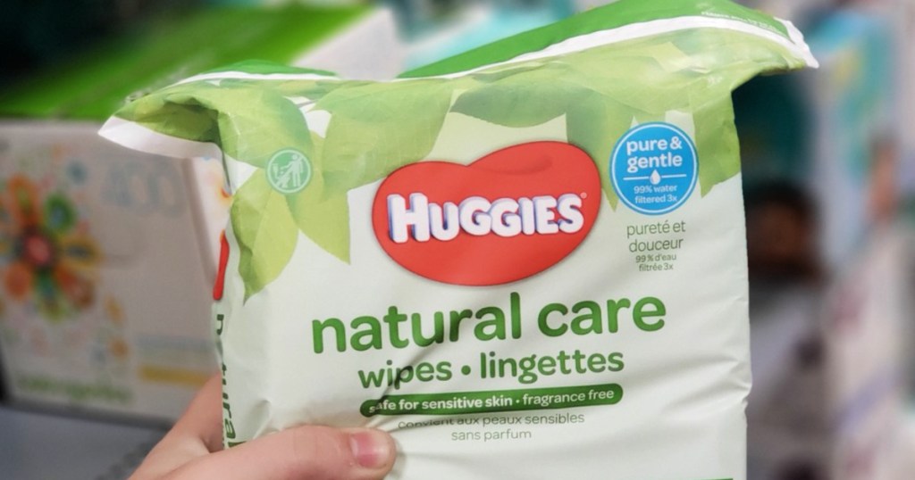 person holding bag of Huggies Natural Care Wipes
