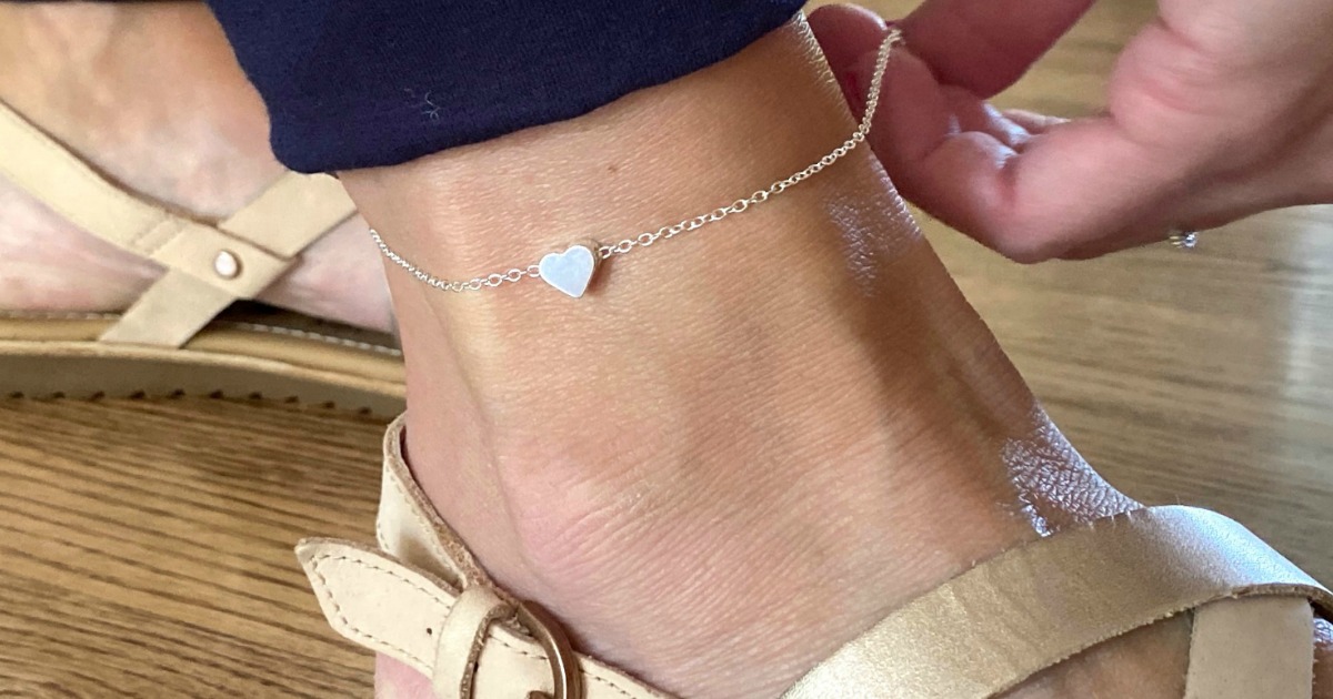 putting on anklet with heart