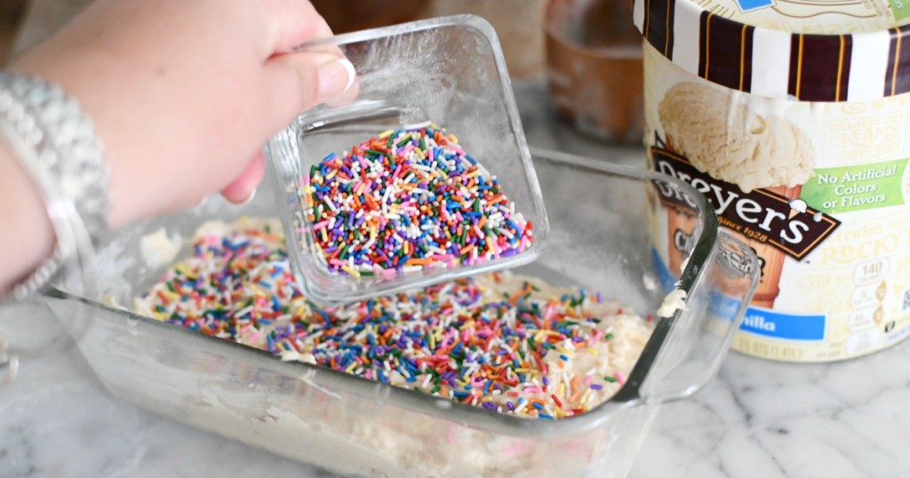 putting sprinkles on ice cream cake