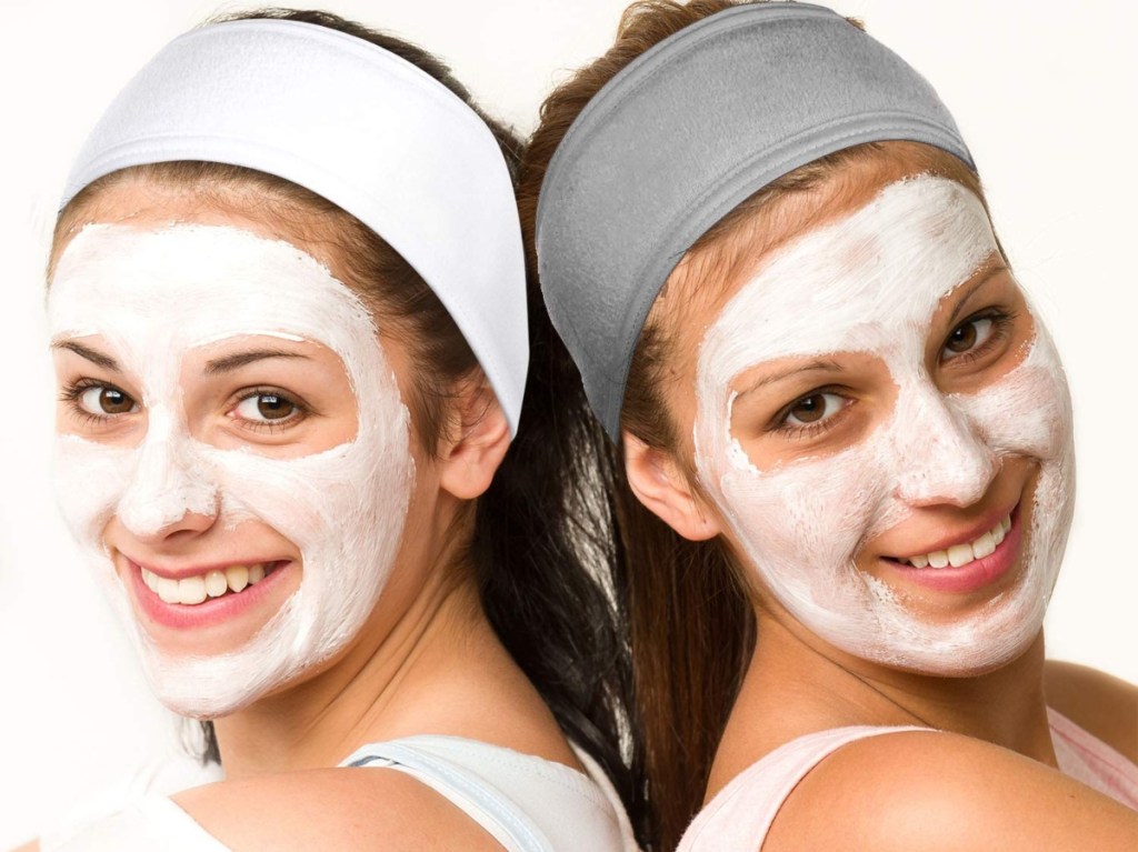 2 women wearing white facial masks and headbands