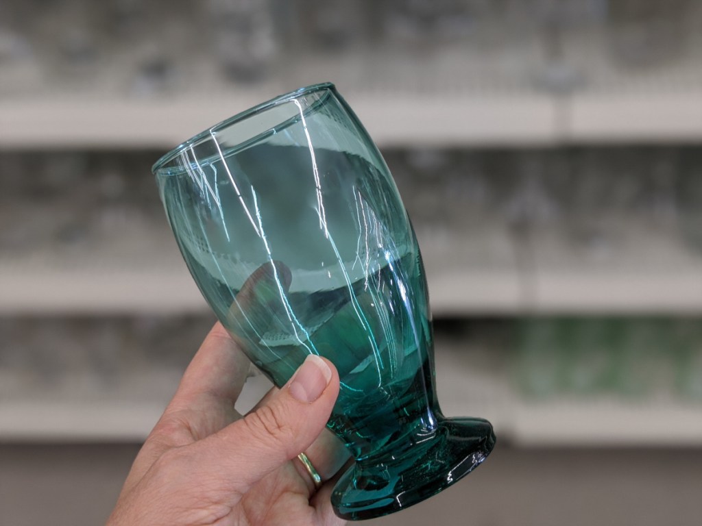 hand holding green goblet in store
