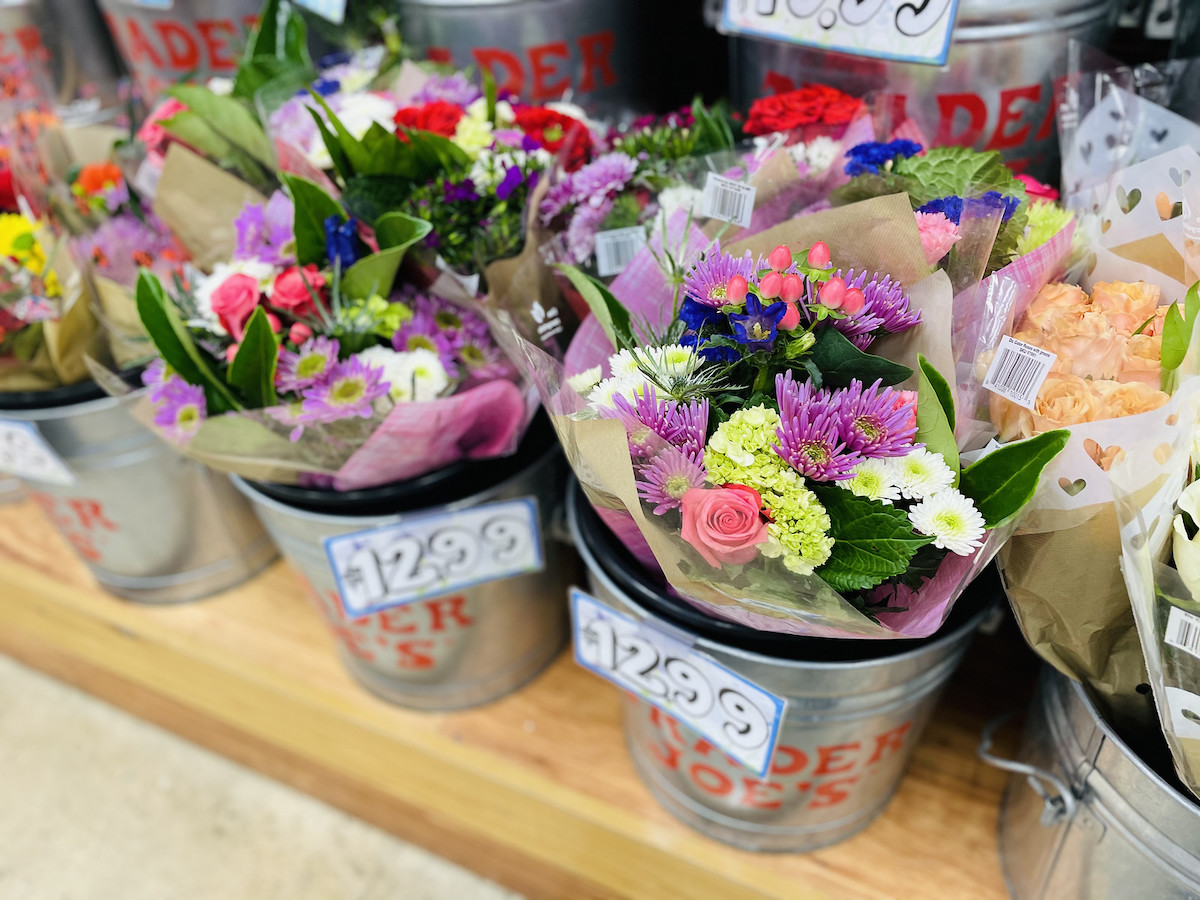 bouquets of colorful flowers in trader joes buckets 