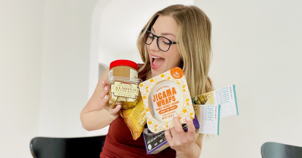 woman holding a bunch of the best trader joes foods