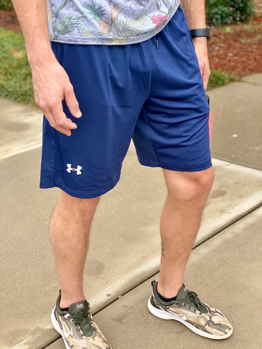 man wearing blue ua shorts with nike shoes 