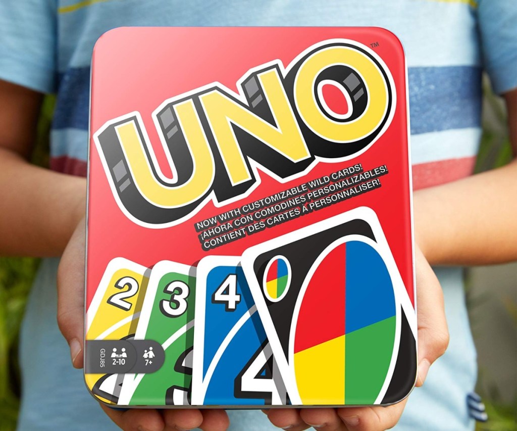 boy holding uno game in metal tin