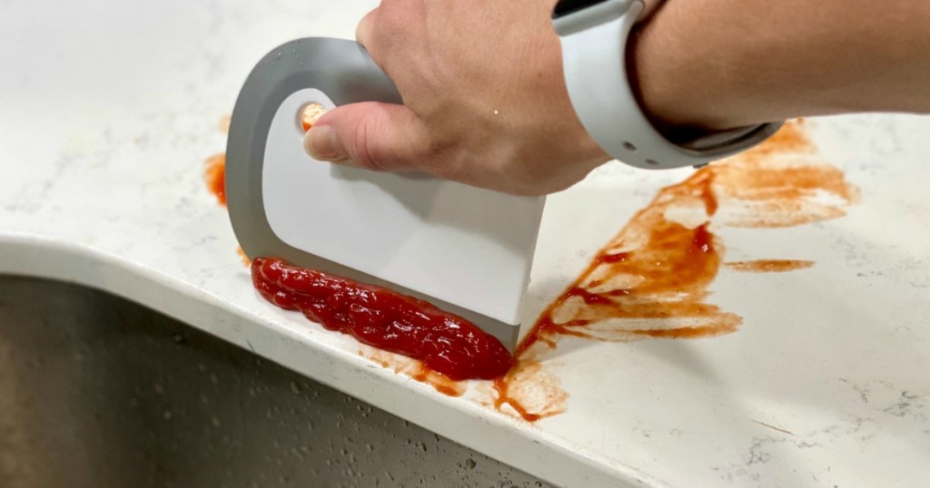 using OXO dish squeegee to remove ketchup from countertop 