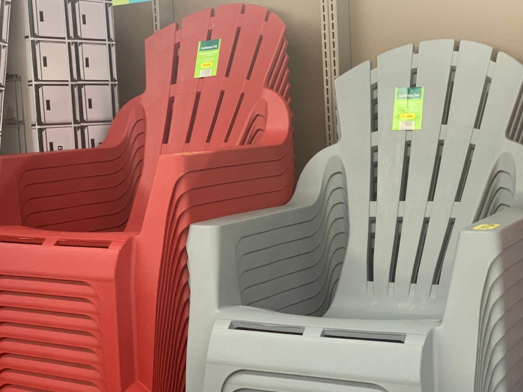 red and light grey plastic adirondack chairs in store stacked