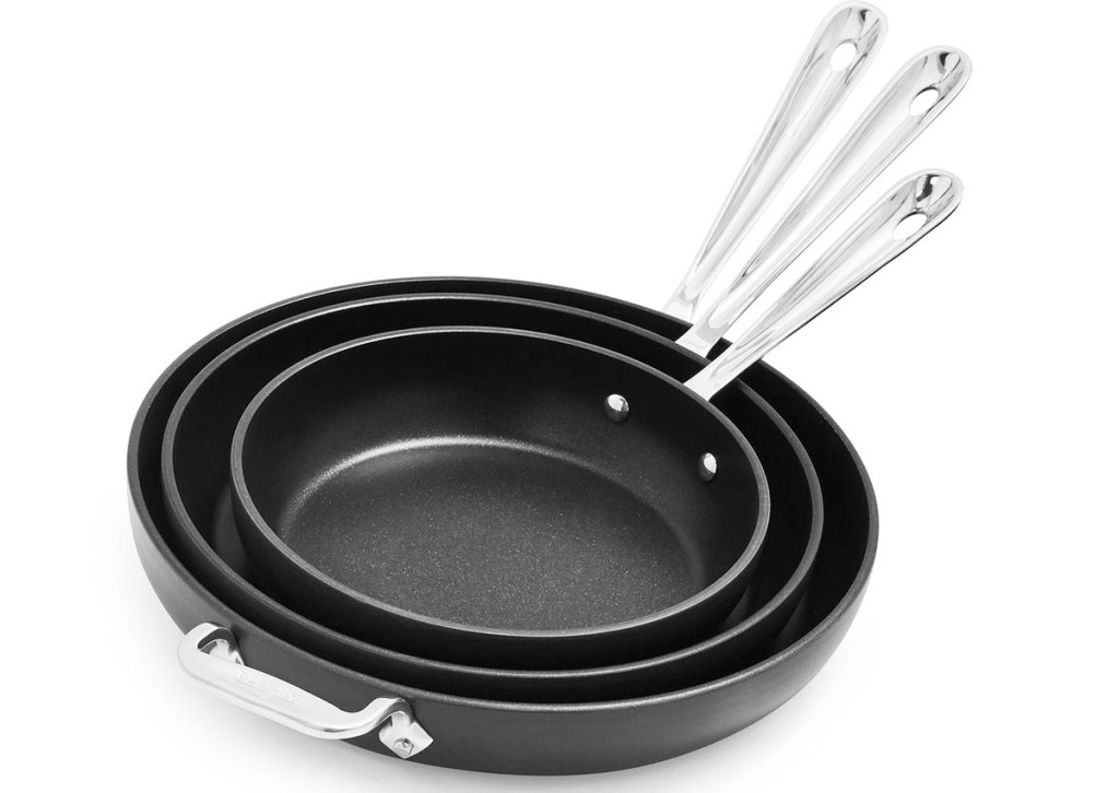 set of three black nonstick frying pans with silver handles
