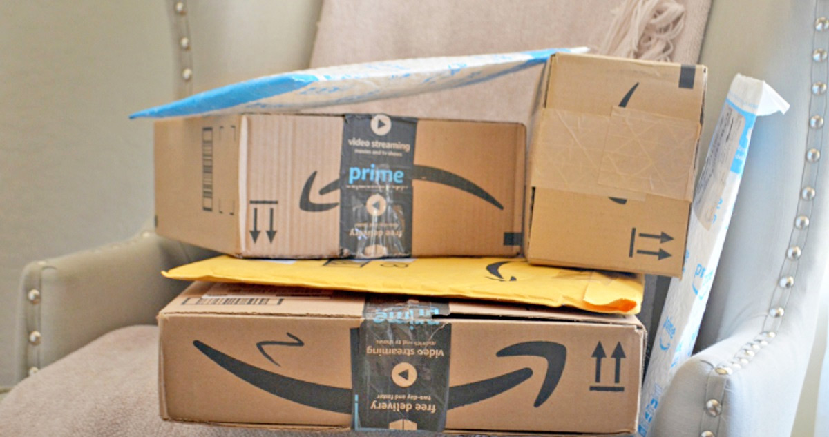 amazon boxes and packages stacked on an accent chair