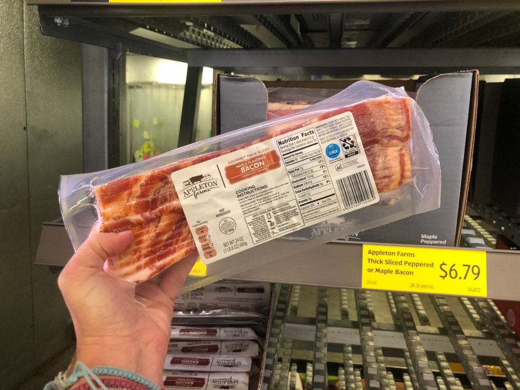 hand holding Appleton Farms Thick Sliced Flavored Bacon