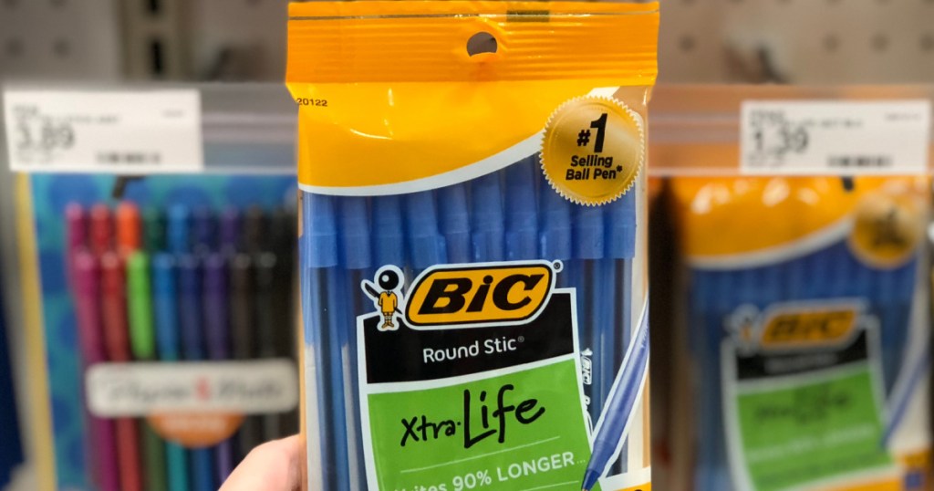 hand holding pack of blue pens in store