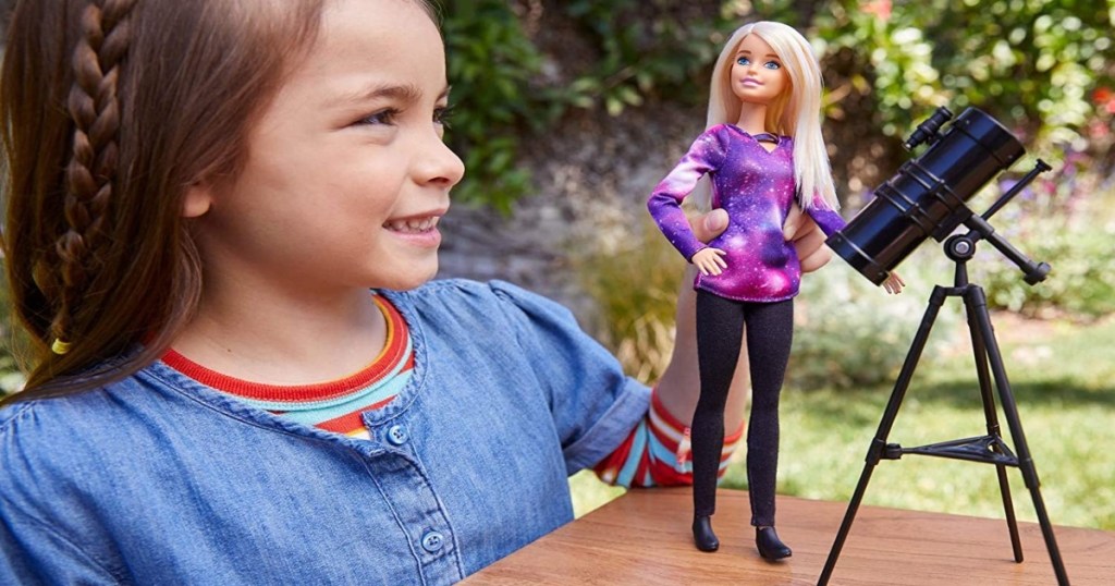 girl playing outside with Barbie Astrophysicist Doll