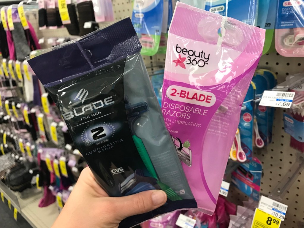 hand holding two packages of razors