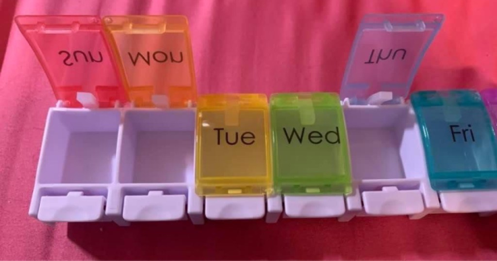 pill organizer opened with pink background