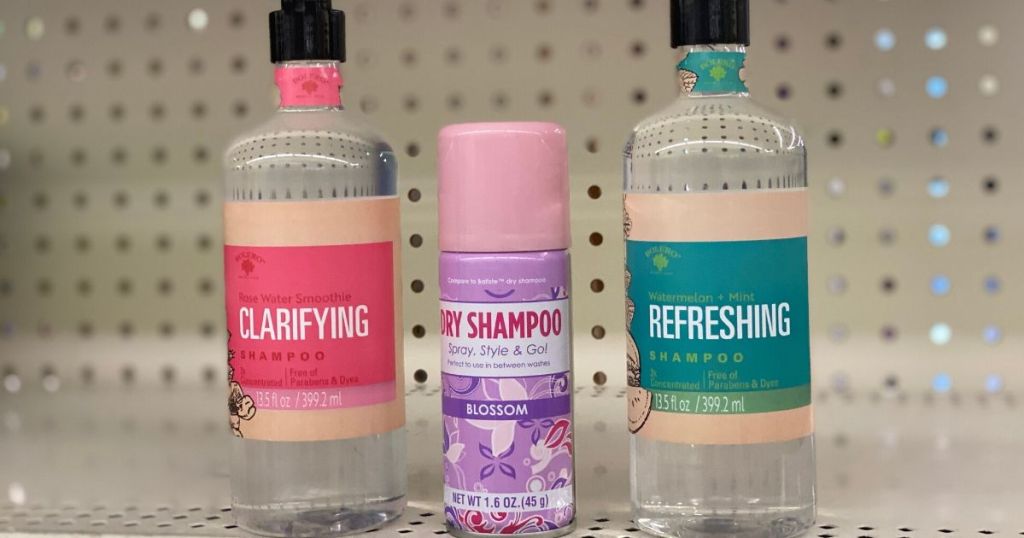 two bottles of shampoo and a bottle of Dry shampoo on store shelf