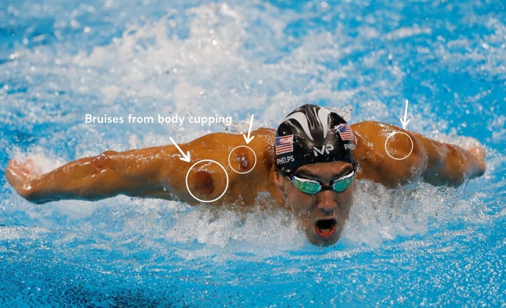 A professional swimmer wearing goggles in a pool