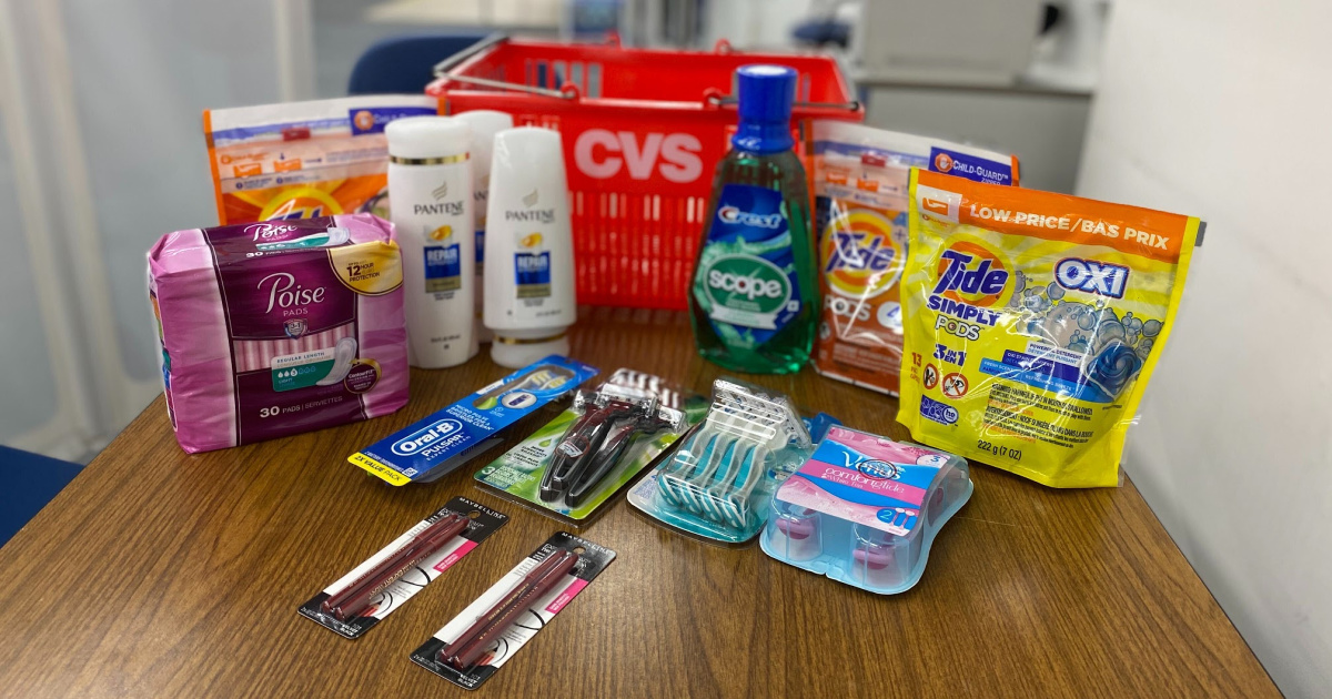 cvs basket with poise, toothbrushes, tide, scope, pantene, and razors on counter top