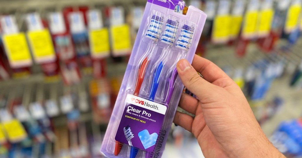 CVS Health 3-Pack toothbrushes in person's hand
