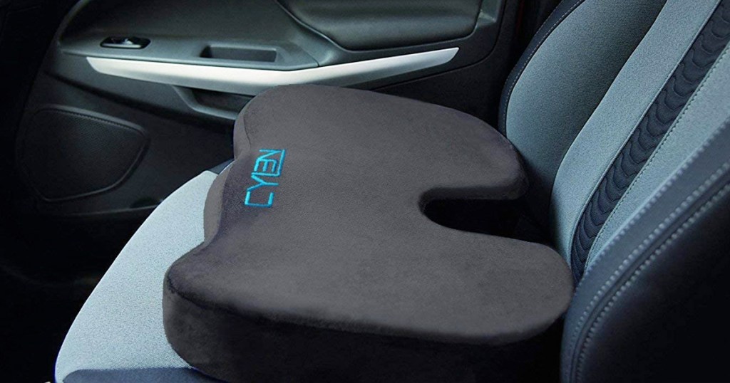 black memory foam seat cushion on seat inside a car