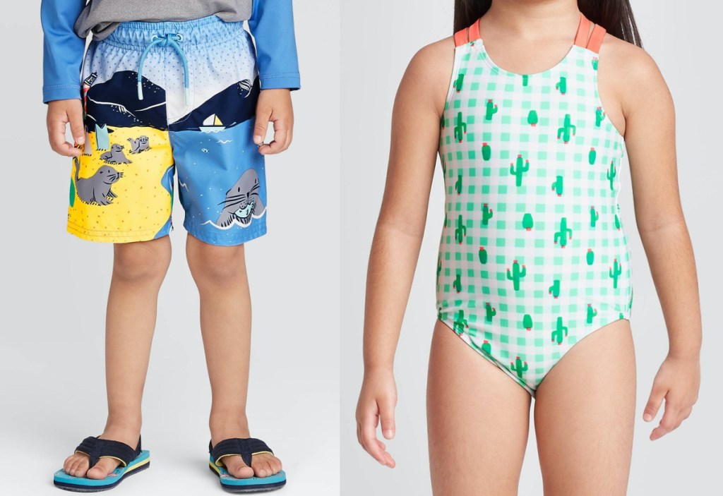 boy in swimming trunks and sandals and girl in green cactus one piece swimsuit