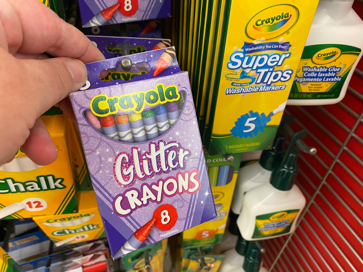 hand holding Crayola Glitter Crayons in store