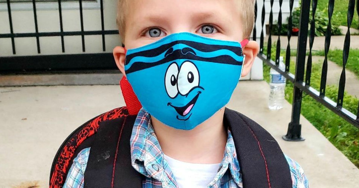 little boy wearing a blue face mask
