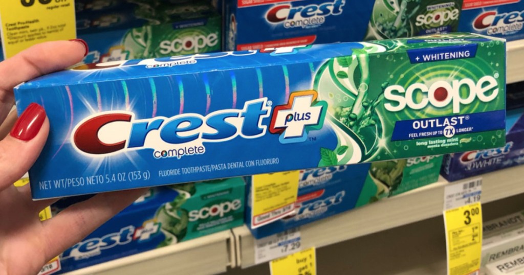 Crest complete toothpaste in person's hand