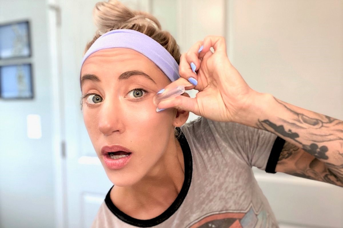 A woman cupping under eye areas
