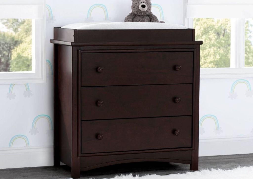 brown dresser with bear on top