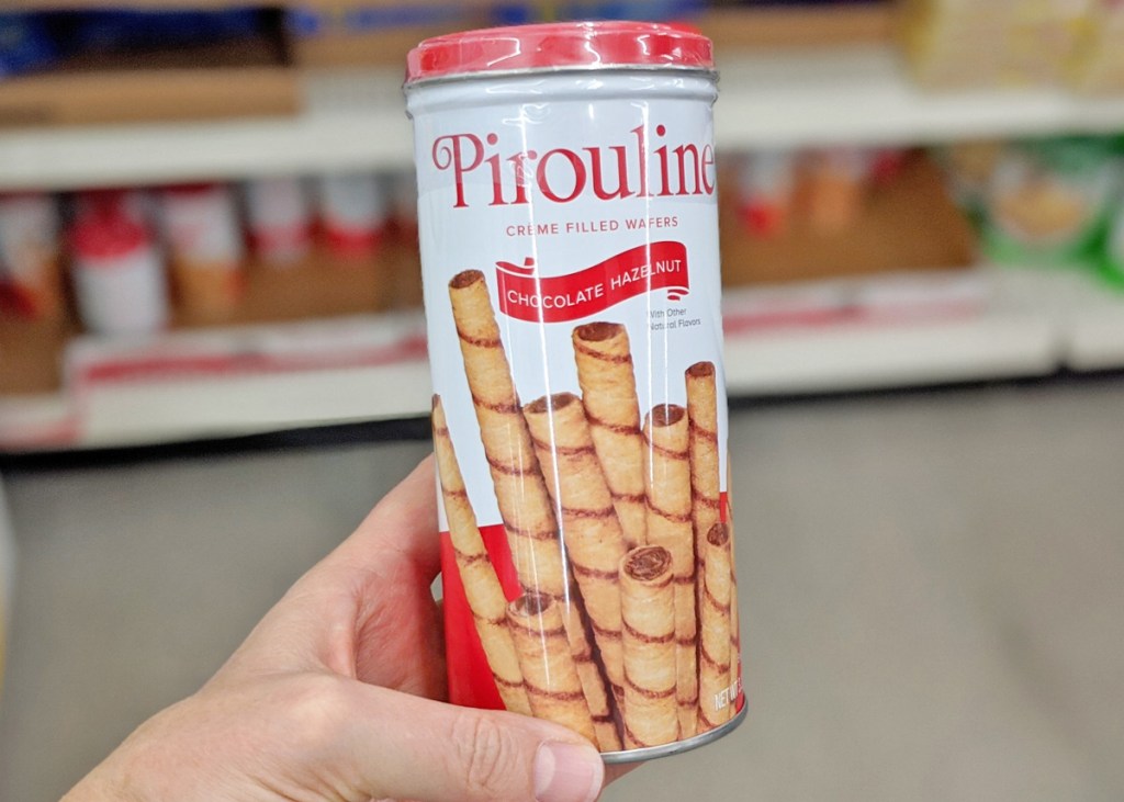 person holding up a white can of pirouline chocolate hazelnut rolled waffers