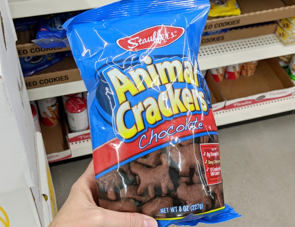 person holding blue back of chocolate animal crackers