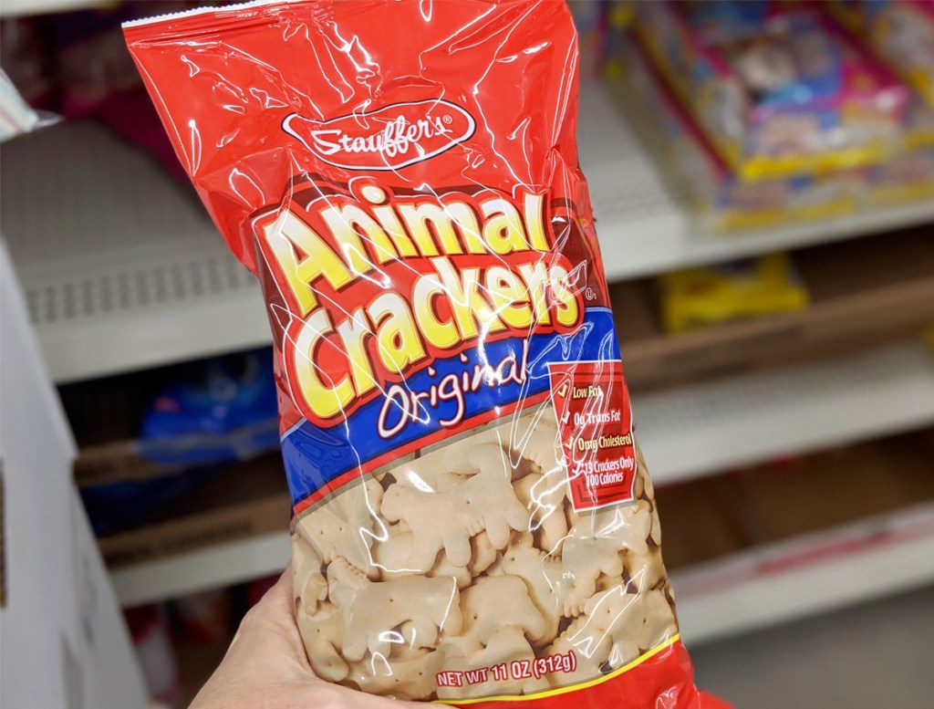 person holding up a red bag of original animal crackers