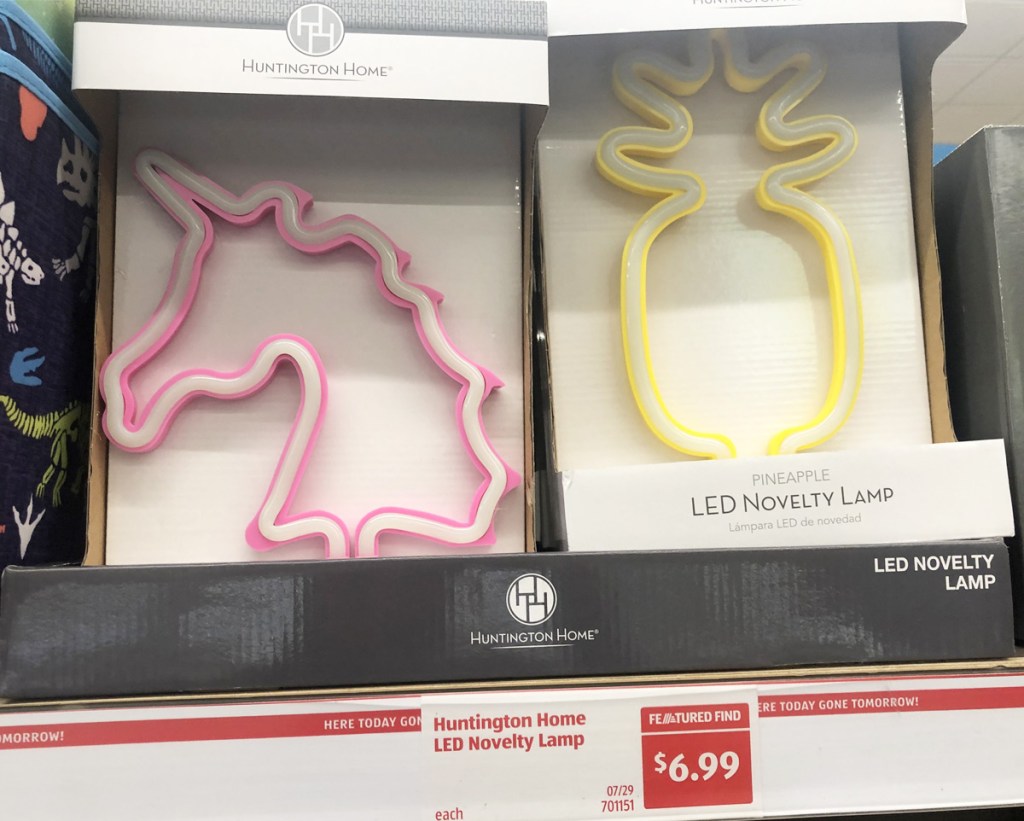 pink unicorn and yellow pineapple shaped LED lights on store shelf