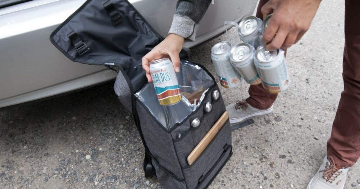 man loading cans into soft cooler bag