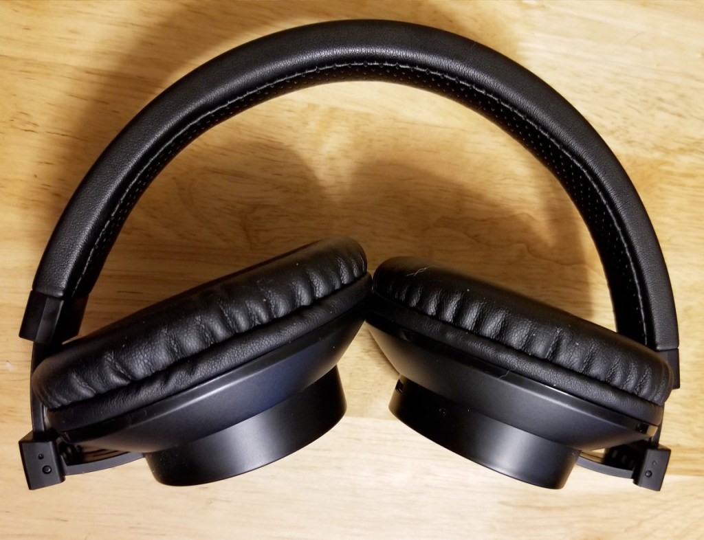 black pair of over-the-ear headphones with ear pieces folded in
