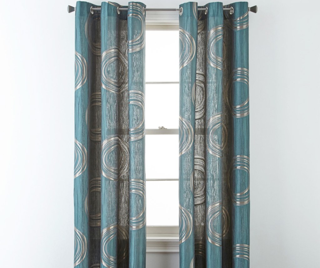 teal colored curtain panels with gold circles on white window