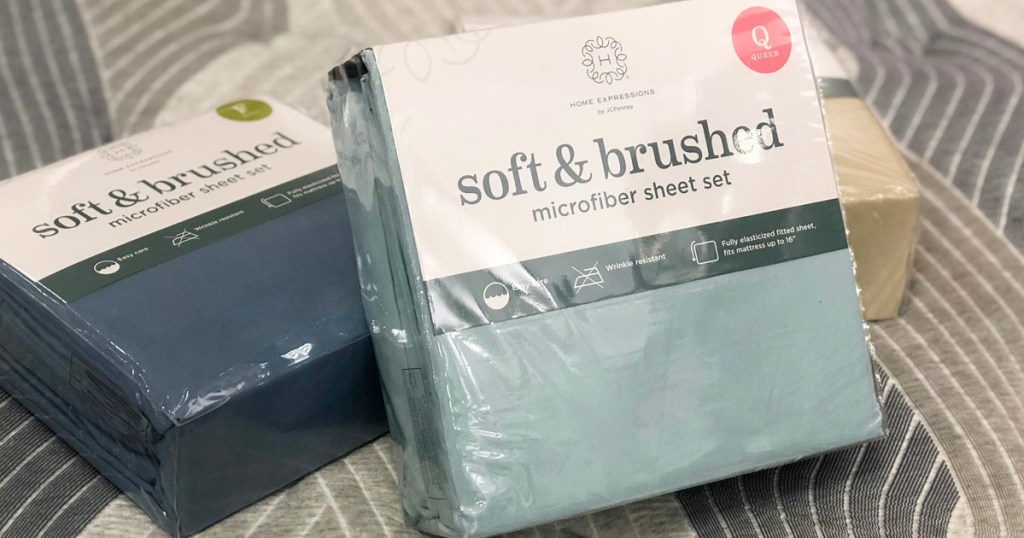 three packages of microfiber sheet sets laying on a bed