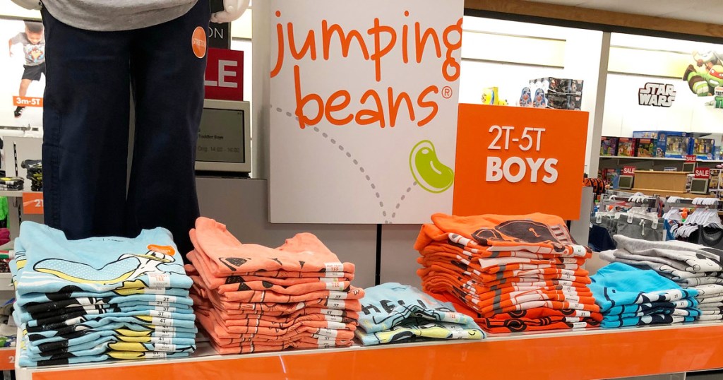 orange and white jumping beans brand sign on store display of folding boys shirts in store