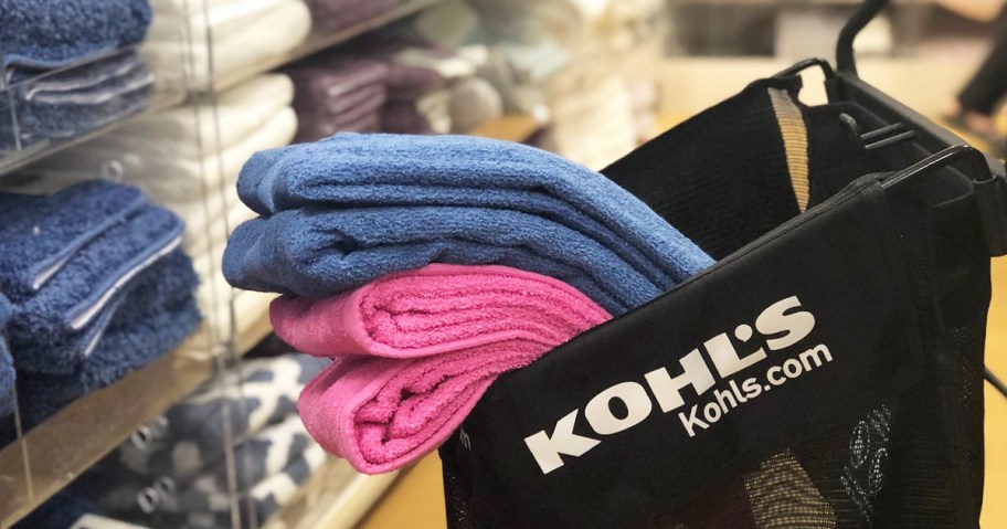 blue and pink bath towels inside a black kohl's shopping cart