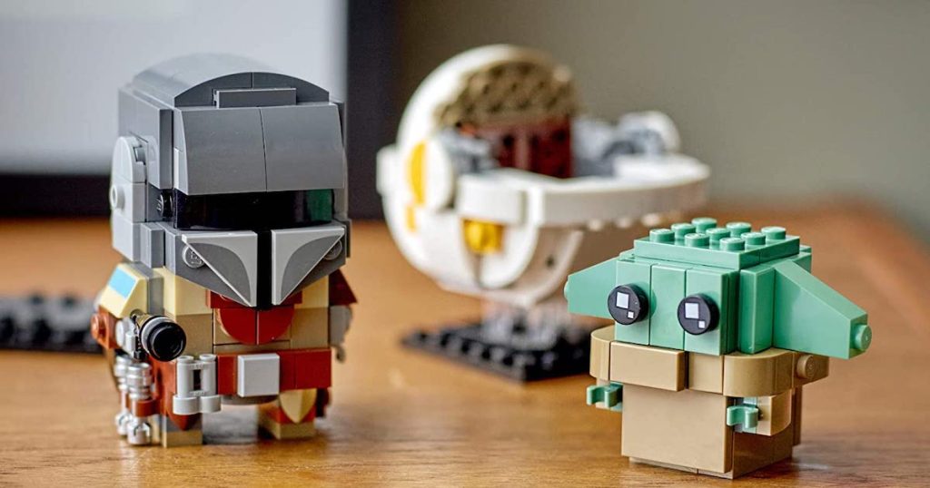 put together LEGO BrickHeadz Star Wars The Mandalorian & The Child with the child pod behind him
