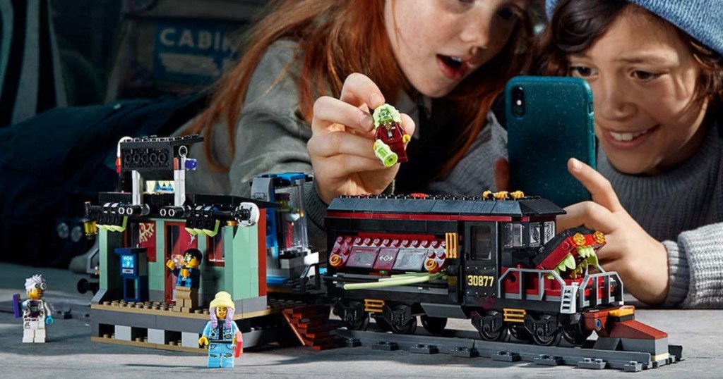 two kids playing with lego ghost train