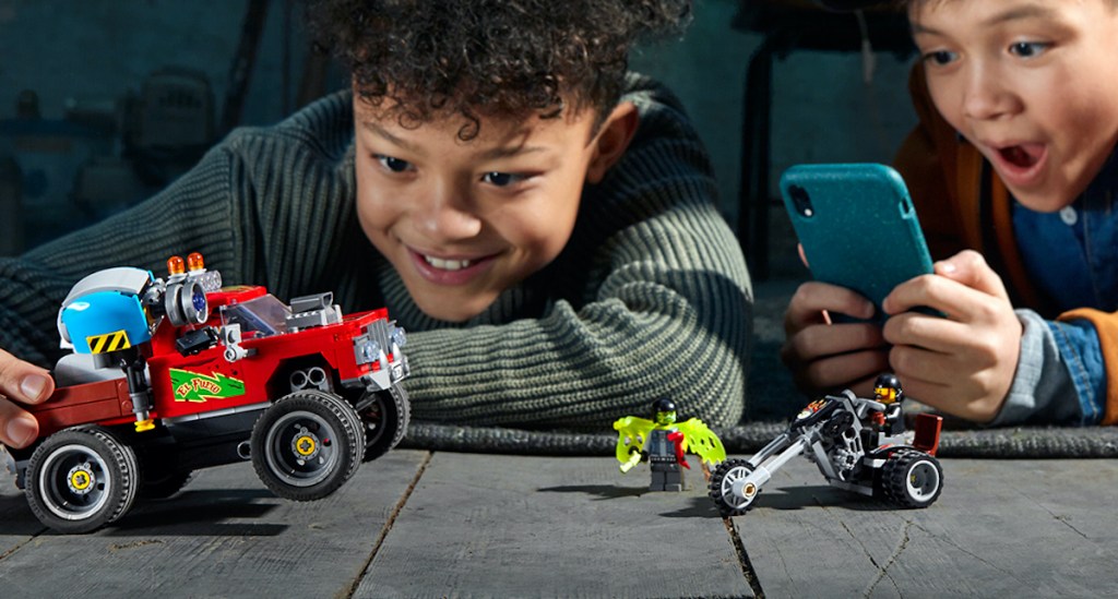 two boys playing with LEGO Hidden Side Augmented Reality (AR) El Fuego's Stunt Truck Model Set