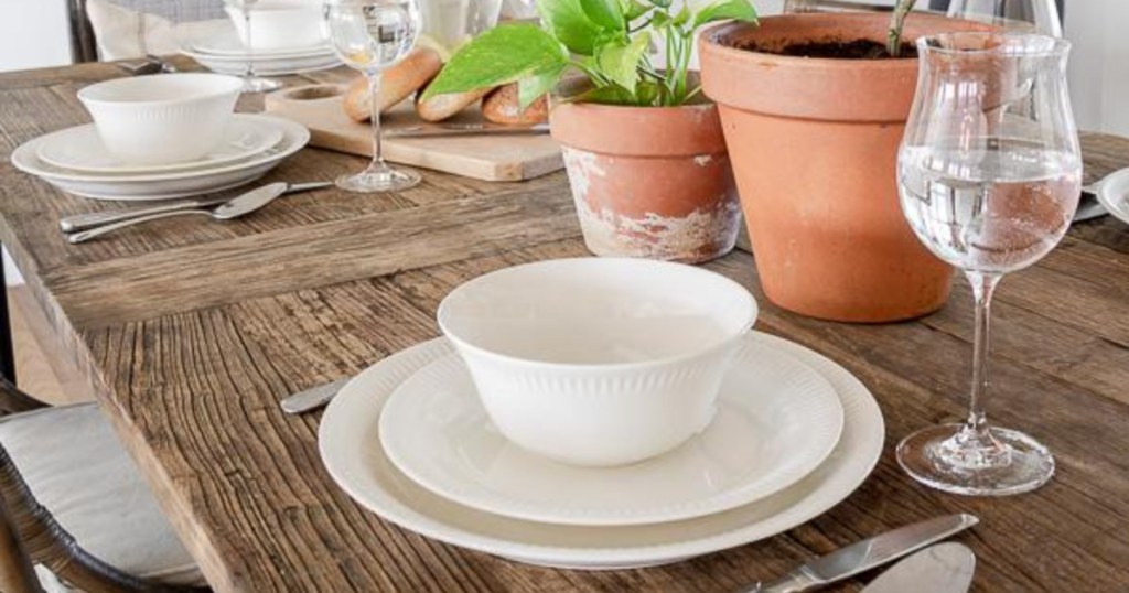 lenox bowl, salad plate, and dinner plate stacked up together on rustic dining room table