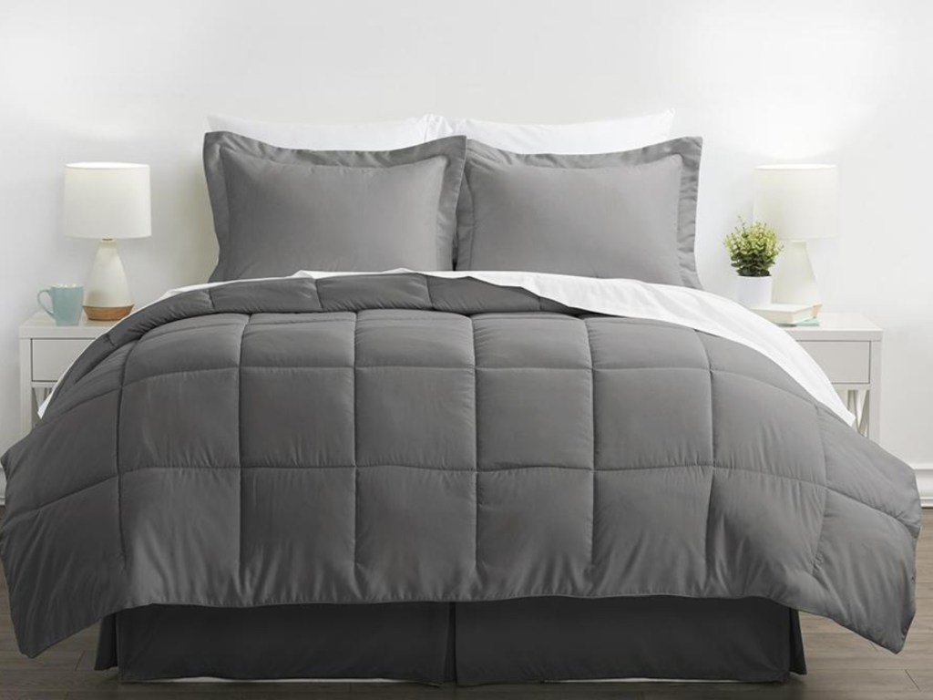 grey alternative down comforter on a bed with pillows and shams