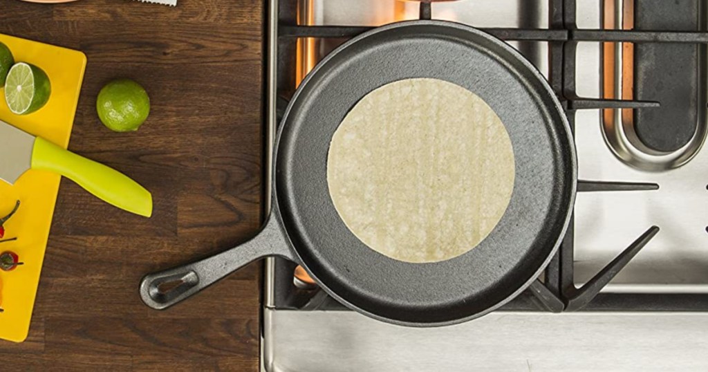 lodge cast iron griddle cooking a tortilla on a gas range