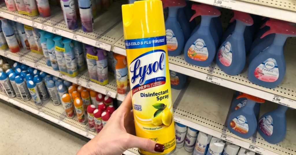 hand holding bottle of Lysol Disinfectant Spray