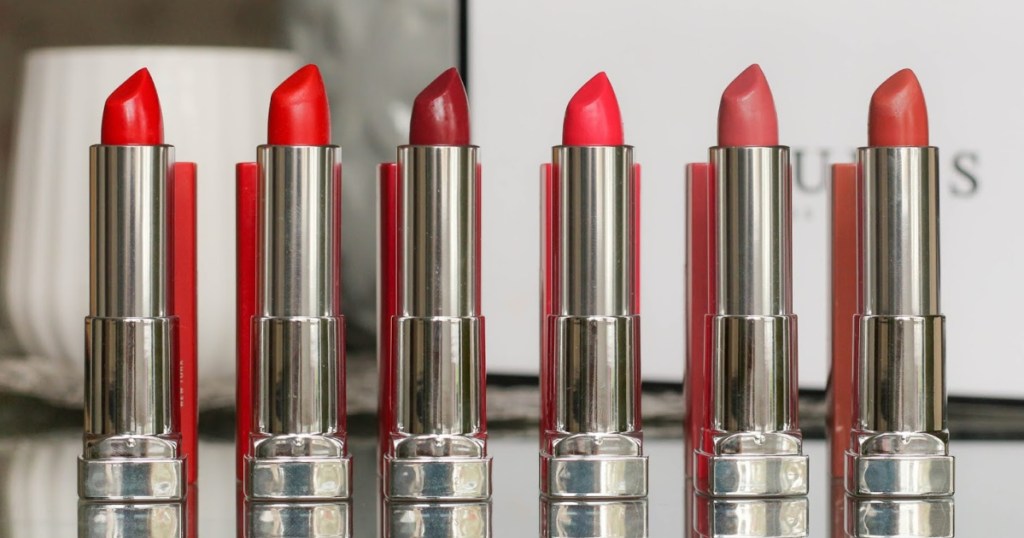 various colored lipsticks lined up on table