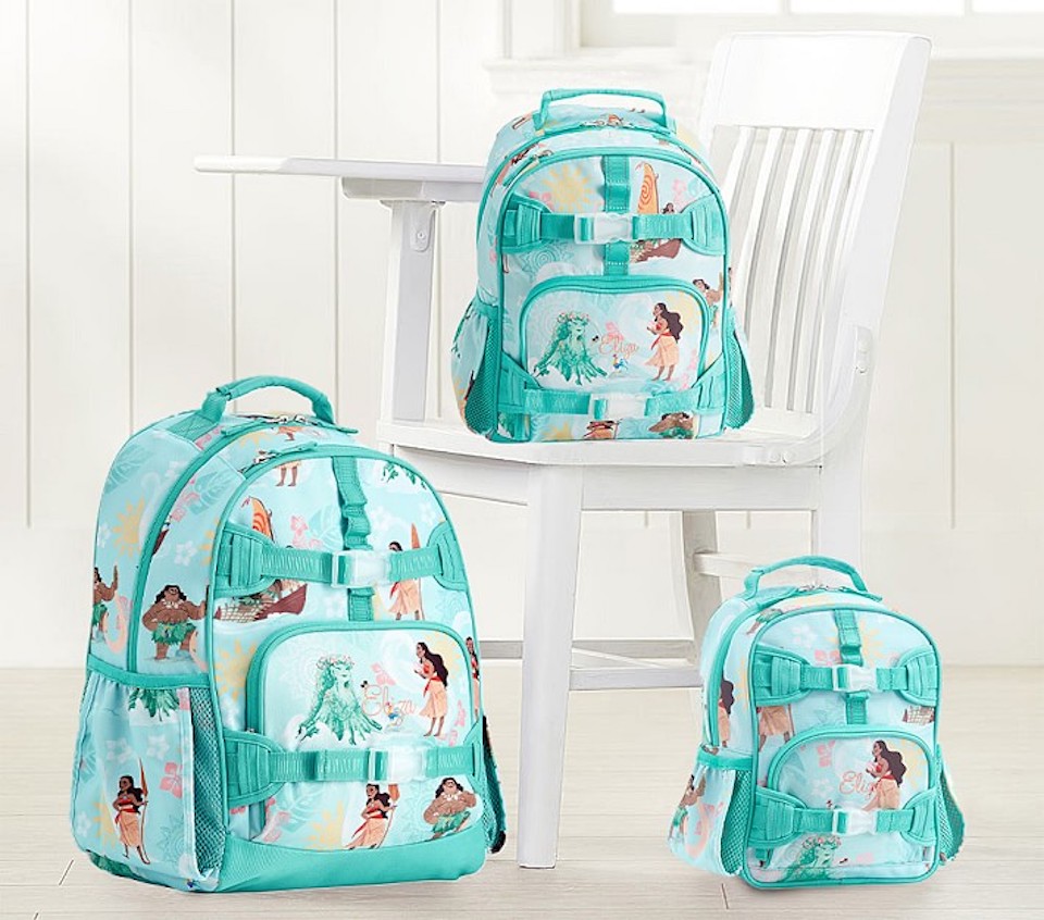 three kids backpacks next to a chair