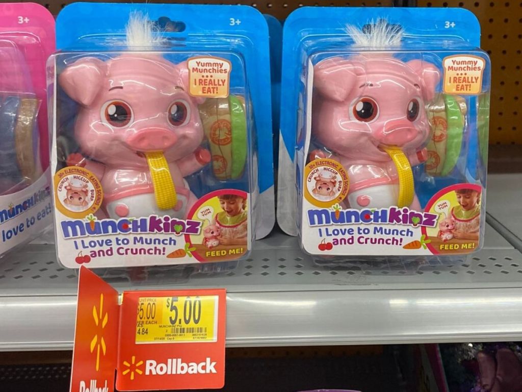 little plastic interactive pig toys on shelf in plastic packages