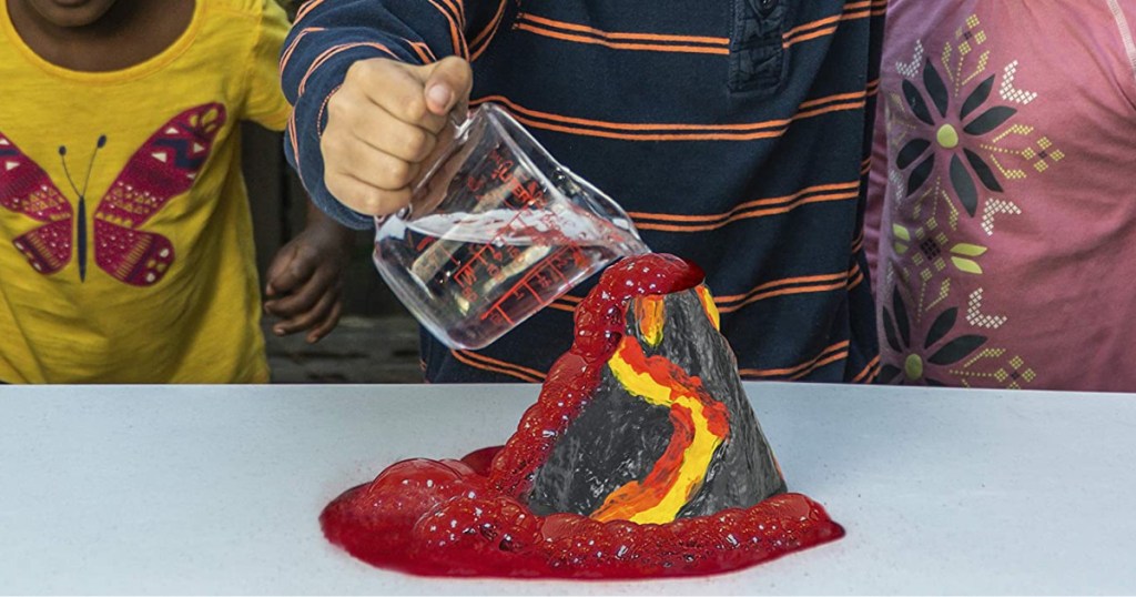 children playing with volcano science kit on table